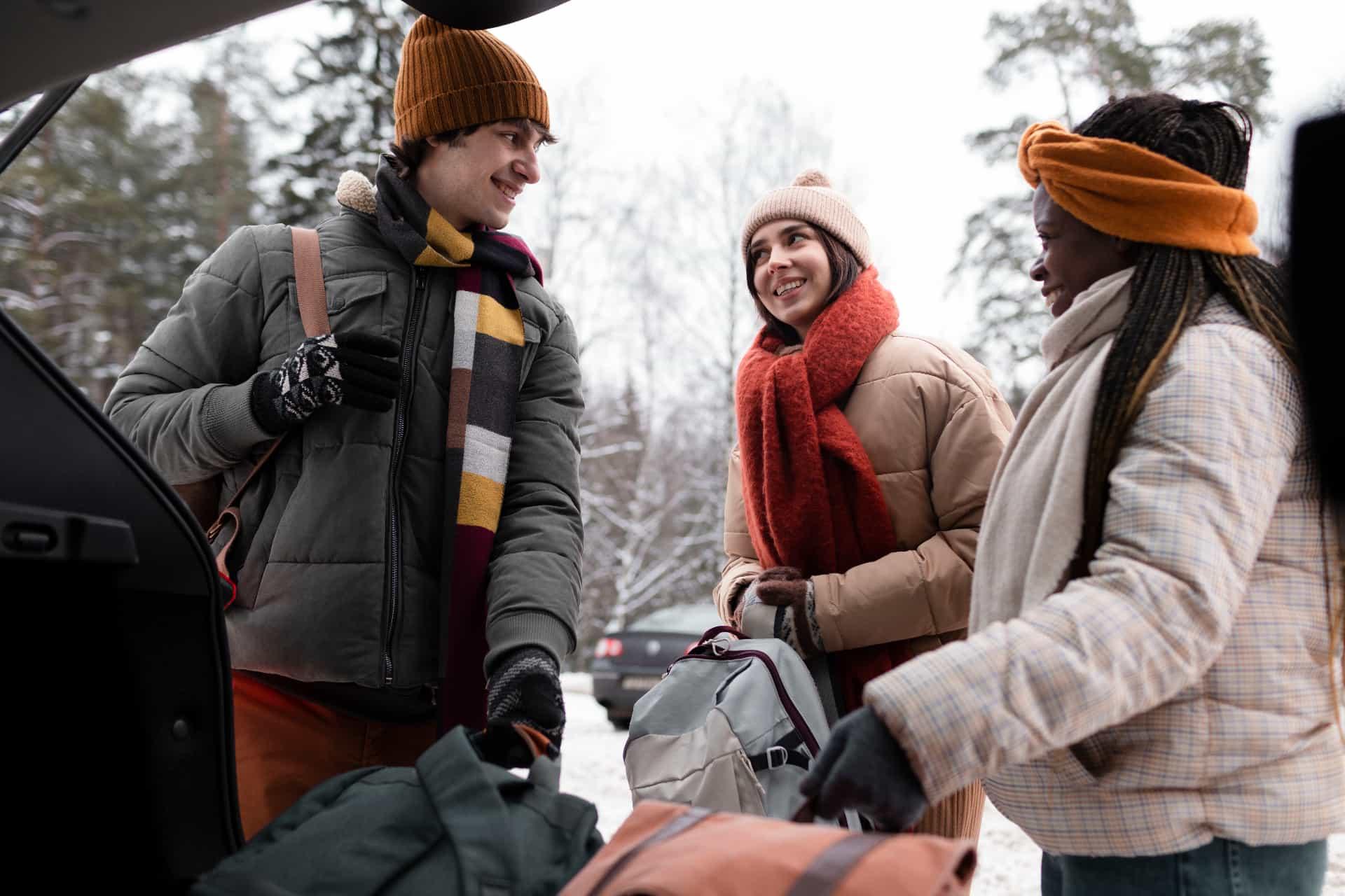 Friends loading luggage into car for a trip